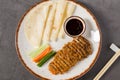Sliced crispy duck served with pancakes, hoisin sauce, and vegetables Royalty Free Stock Photo