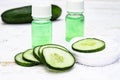 Sliced cucumber and a bottle of cucumber extract. Liquid cosmetics for skin care