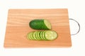 sliced cucumber on the cutting board isolated on the white background Royalty Free Stock Photo