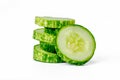 Sliced cucumbers for fresh vegetables, in a stacked composition, isolated on a white background Royalty Free Stock Photo