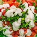 Sliced cucumbers, tomatoes, onions, mayonnaise. Ingredients for the salad. Salad on spoon. Blurred background Royalty Free Stock Photo