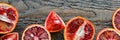 Sliced and cut Sicilian blood oranges on wooden natural background Royalty Free Stock Photo