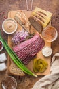 Sliced Deli Pastrami on wooden board, flat lay