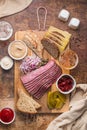 Sliced Deli Pastrami on wooden board, flat lay