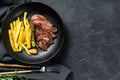 Sliced Denver steak with French fries, marbled meat. Black background. Top view. Copy space Royalty Free Stock Photo
