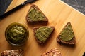 Sliced diet grain bread spread with pesto sauce Royalty Free Stock Photo