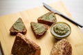 Sliced diet grain bread spread with pesto sauce Royalty Free Stock Photo