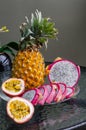 Exotic tropical delicious Thai fruit passion fruit pineapple dragonfruit on a glass table