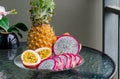Exotic tropical delicious Thai fruit passion fruit pineapple dragonfruit on a glass table