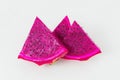 Sliced dragon fruit on plain background. Vibrant pink color and seeds. Royalty Free Stock Photo