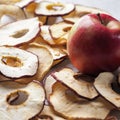 Sliced dried apples ready to eat on a wooden table and fresh apple . Top view Royalty Free Stock Photo