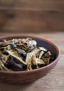 Sliced dried mushrooms lie in a clay plate close-up, copy space Royalty Free Stock Photo