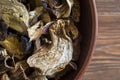 Sliced dried mushrooms lie in a clay plate close-up, top view Royalty Free Stock Photo