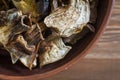 Sliced dried mushrooms lie in a clay plate close-up, top view Royalty Free Stock Photo