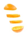 Sliced flying orange isolated on white background. cut orange in pieces isolated on white background. Levity fruit floating in the Royalty Free Stock Photo