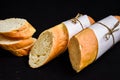 Sliced french baguette with crumbs on dark background Royalty Free Stock Photo