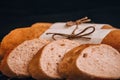 Sliced french baguette with crumbs on dark background Royalty Free Stock Photo