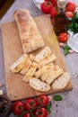 Sliced French bread baguette on wooden bread board Royalty Free Stock Photo