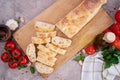 Sliced French bread baguette on wooden bread board Royalty Free Stock Photo