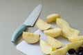 Sliced fresh apples, kitchen knife on side, fresh summer fruits from market