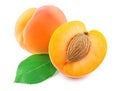 Sliced fresh apricots with a vibrant leaf on white Royalty Free Stock Photo