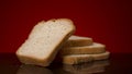 Sliced fresh bread lies on the black table. Stock footage. Close up of hand taking one of the slices of baked white cut Royalty Free Stock Photo