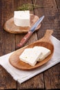 Sliced fresh brined white cheese from cow milk on wooden table