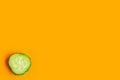 Sliced fresh cucumber isolated on orange background, top view, minimal concept, copy space Royalty Free Stock Photo