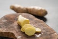 Sliced fresh ginger root on olive wood board Royalty Free Stock Photo