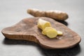 Sliced fresh ginger root on olive wood board Royalty Free Stock Photo