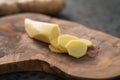 Sliced fresh ginger root on olive wood board Royalty Free Stock Photo