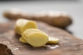 Sliced fresh ginger root on olive wood board Royalty Free Stock Photo