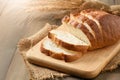 Sliced of fresh homemade french breads on wood background