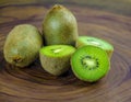 Sliced fresh and juicy kiwi fruit halves on a wooden background Royalty Free Stock Photo