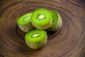 Sliced fresh and juicy kiwi fruit halves on a wooden background Royalty Free Stock Photo