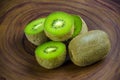 Sliced fresh and juicy kiwi fruit halves on a wooden background Royalty Free Stock Photo