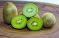 Sliced fresh and juicy kiwi fruit halves on a wooden background Royalty Free Stock Photo