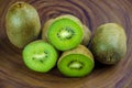 Sliced fresh and juicy kiwi fruit halves on a wooden background Royalty Free Stock Photo