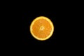 Sliced fresh orange on a deep black backround