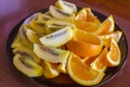Sliced Fresh Orange and Golden Kiwi Fruit on a Plate; Auckland New Zealand Royalty Free Stock Photo