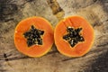 Sliced fresh papaya on wooden background Royalty Free Stock Photo