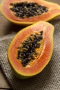 Sliced fresh papaya on wooden background, exotic fresh fruit Royalty Free Stock Photo