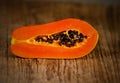 Sliced fresh papaya on wooden background Royalty Free Stock Photo