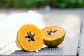 Sliced fresh papaya on a wooden background on the street Royalty Free Stock Photo