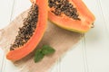 Sliced fresh papaya on wooden background. Top view with copy space Royalty Free Stock Photo