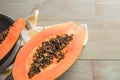 Sliced fresh papaya on wooden background. Top view with copy space Royalty Free Stock Photo