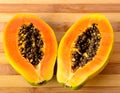 Sliced fresh papaya on wooden background Royalty Free Stock Photo