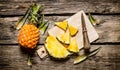 Sliced fresh pineapple with a knife on a chopping Board. Royalty Free Stock Photo