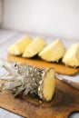 Sliced fresh pineapple on a wooden background in sunlight Royalty Free Stock Photo