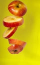 Sliced  fresh red apple in yellow background Royalty Free Stock Photo
